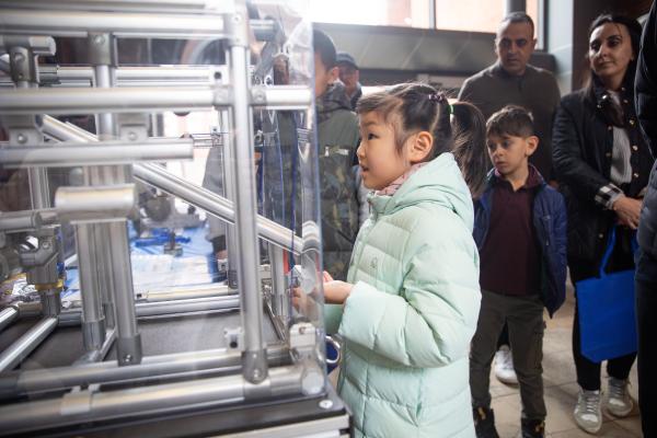 Child engaging with STEM exhibit 