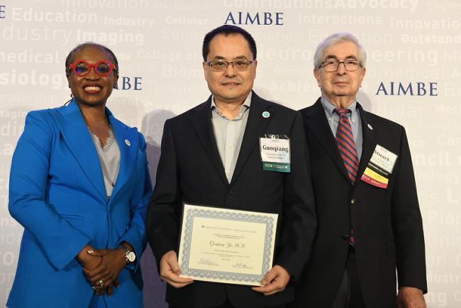 Yu receiving certificate at AIMBE Annual Event