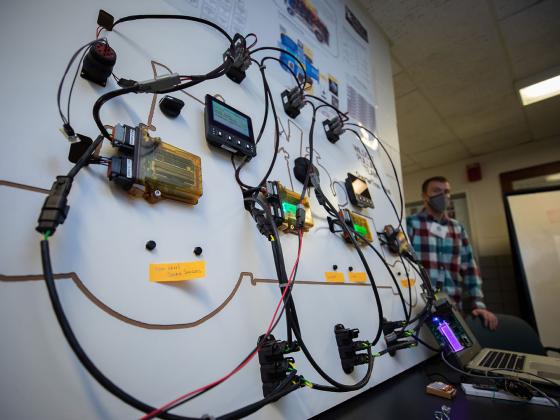 Board of computer parts with wires connecting all of the individual parts.