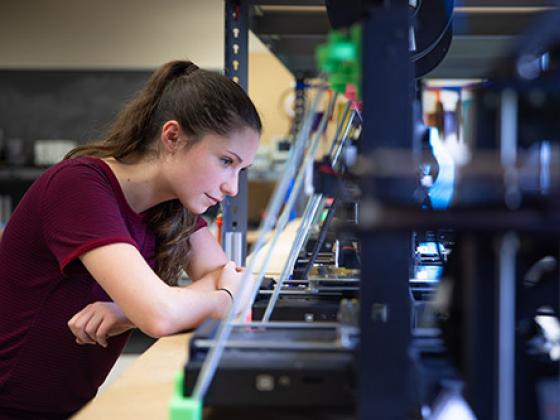 Student working on a 3D printer in the innovation center.