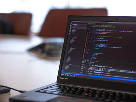 Image of a laptop with code editor screen